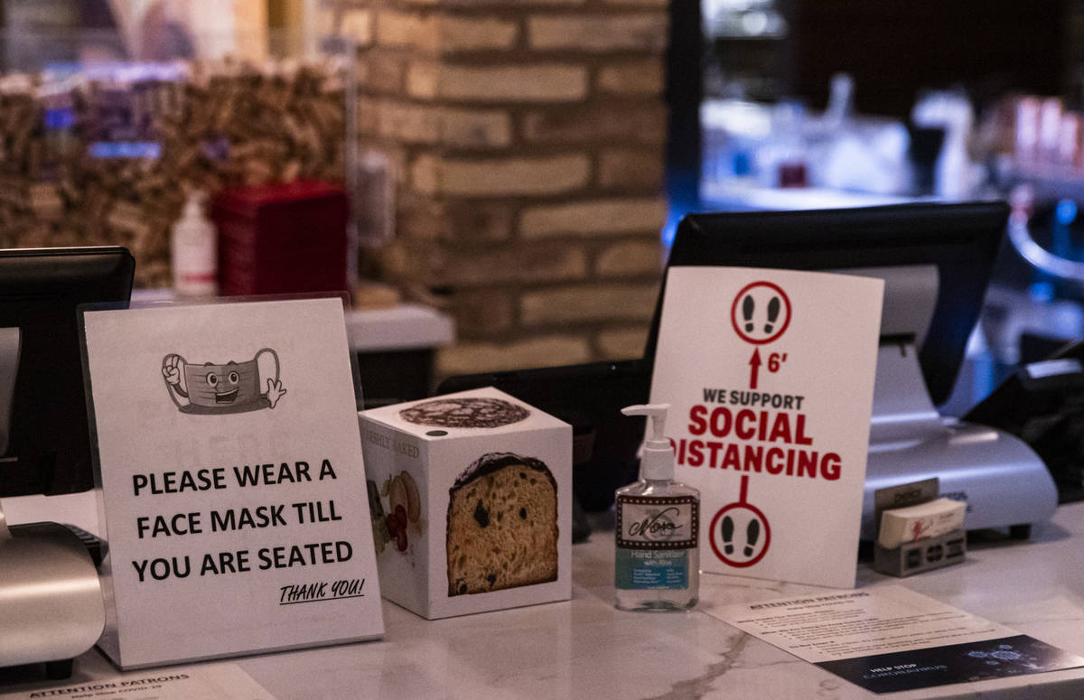 Signs at Nora's Italian Cuisine indicate some of the steps the restaurant is taking to help pre ...