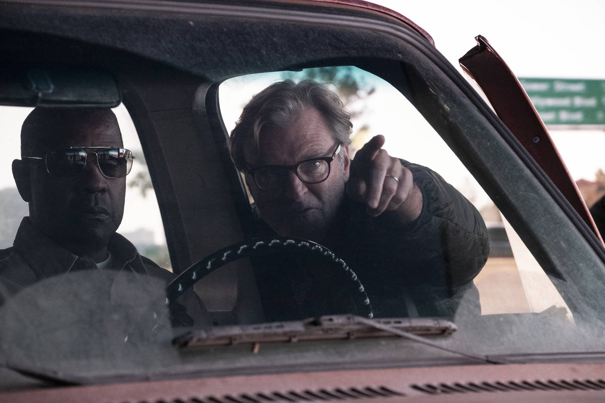 Denzel Washington, left, who portrays an officer with a guilt-ridden past, works with director/ ...