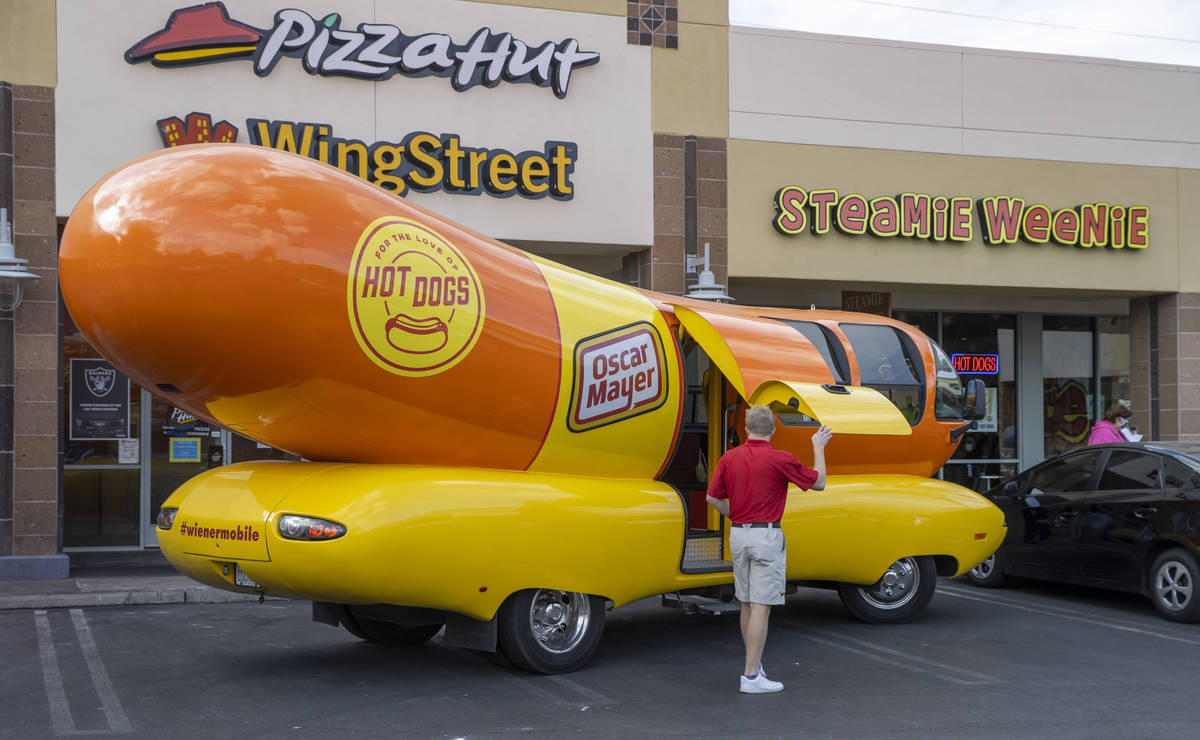 Tommy Salami exits the Oscar Mayer Wienermobile parked outside the Steamie Weenie on Friday, Ja ...