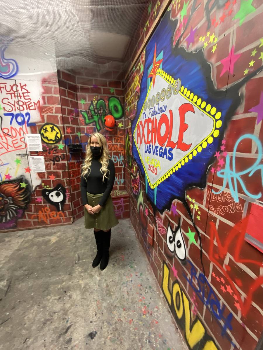 Axehole owner London Cochrane is shown in the "Smash Room" in her business at Neonopolis on Thu ...