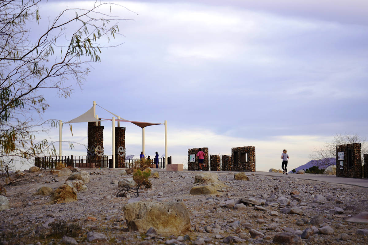 Runners and walkers head up to Sunset Park’s Dune Overlook, a perch that allows views across ...