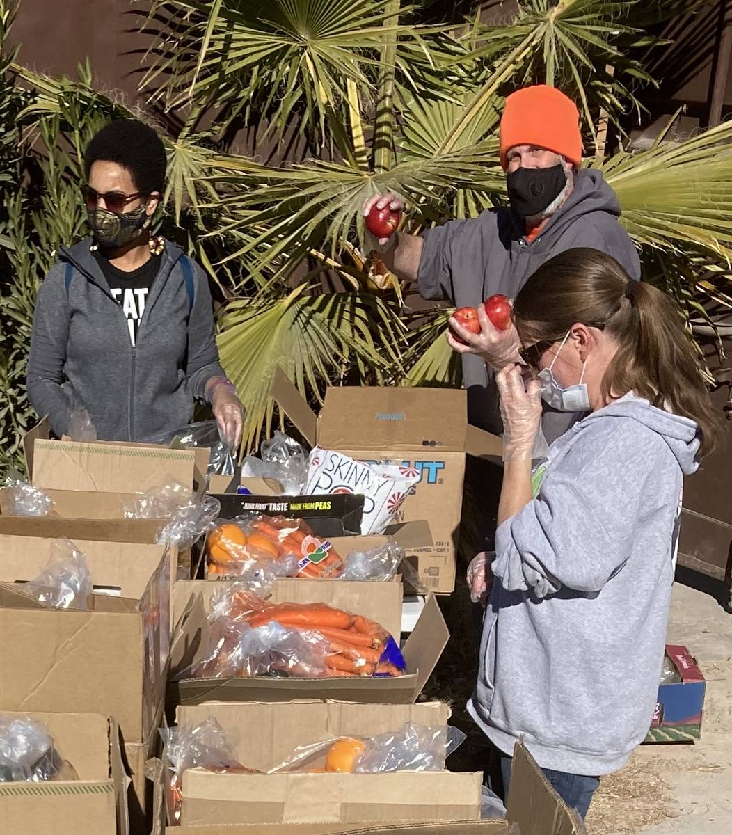 LasVegan Food Bank volunteers assemble grocery boxes on Jan. 23 at the nonprofit RIR Animal San ...