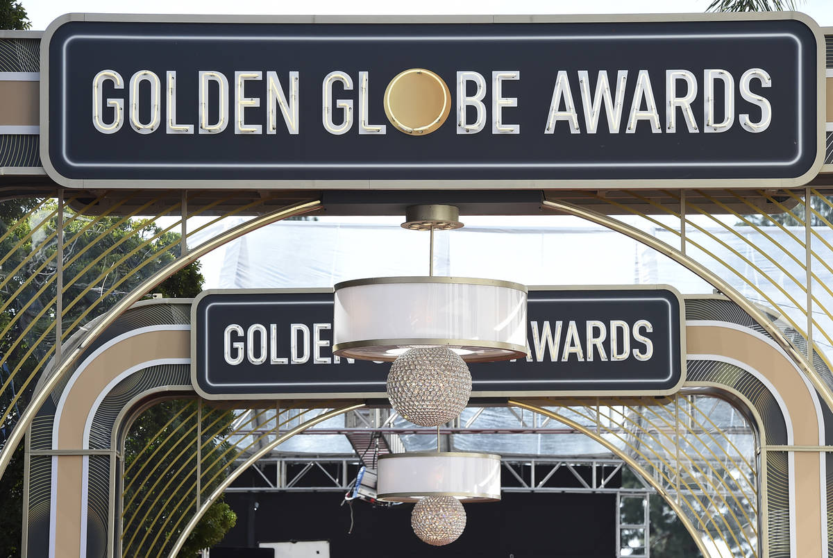 FILE - Event signage appears above the red carpet at the 77th annual Golden Globe Awards, Sunda ...
