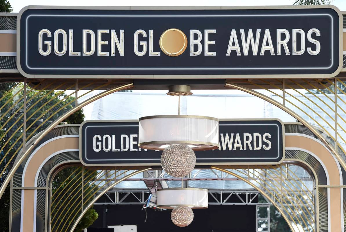 FILE - Event signage appears above the red carpet at the 77th annual Golden Globe Awards, Sunda ...