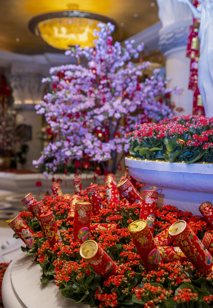 Fireworks and colorful landscaping as part of the decorations for the Lunar New Year near the c ...