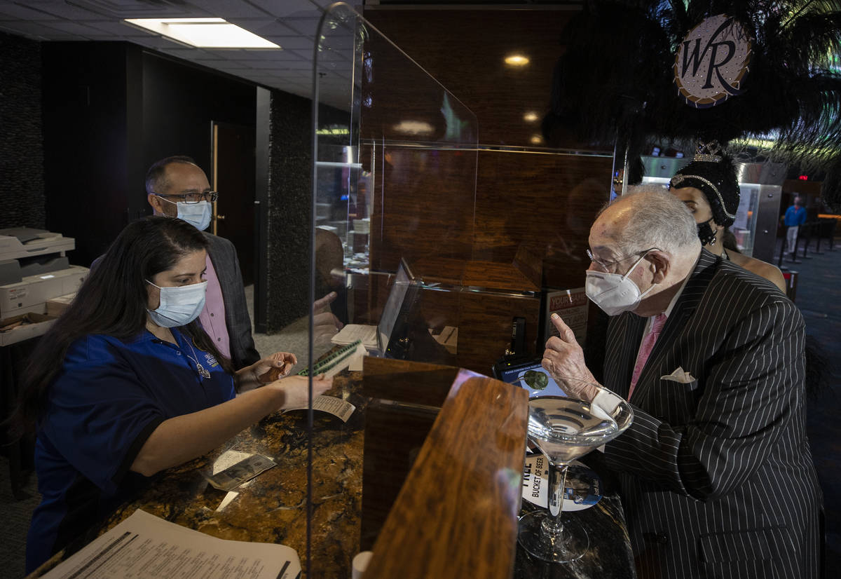 Former Las Vegas Mayor Oscar Goodman, right, places his Super Bowl bet at the Westgate Sportsbo ...