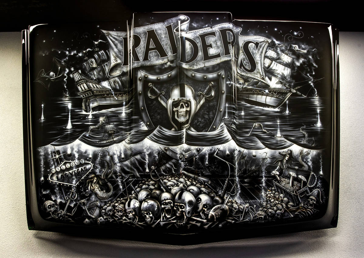 Custom painted hood by artist Craig Fraser above the lighted bar area at the new Diversion Amus ...