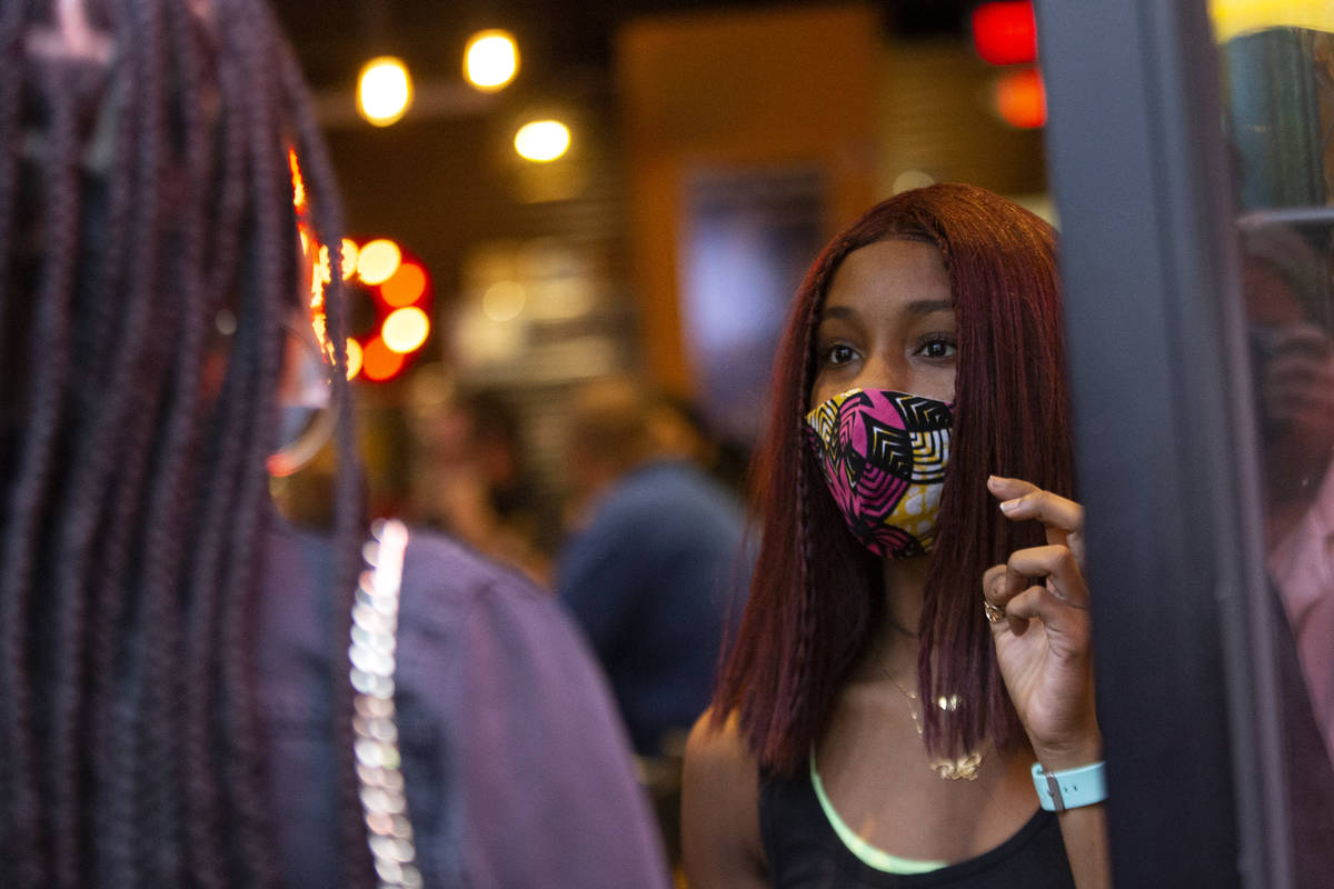 Host Rakia Edmonson counts the number of diners to be seated at Nacho Daddy, where capacity wil ...