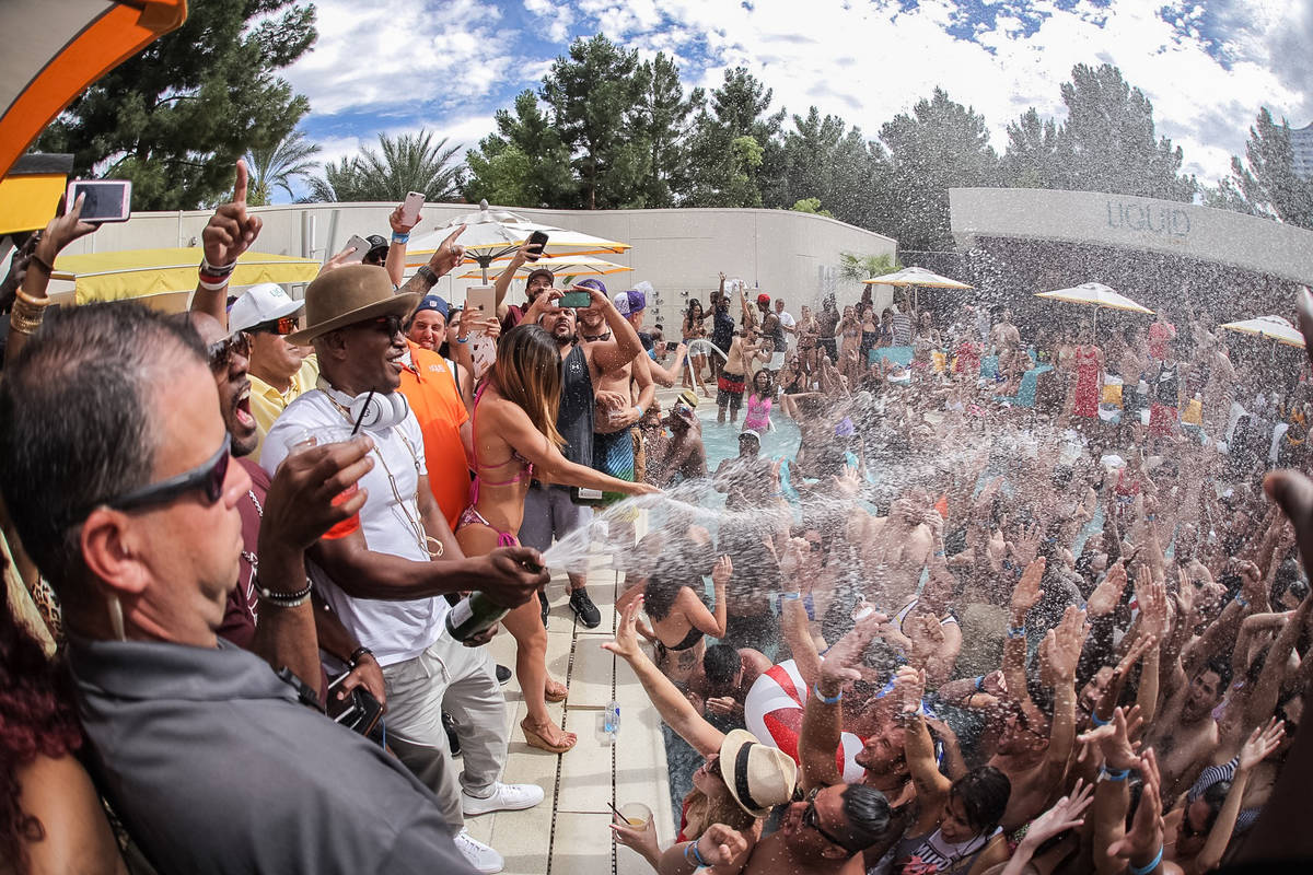 Jamie Foxx sprays champagne at partygoers Saturday, July 9, 2016, at Liquid Pool Lounge at Aria ...