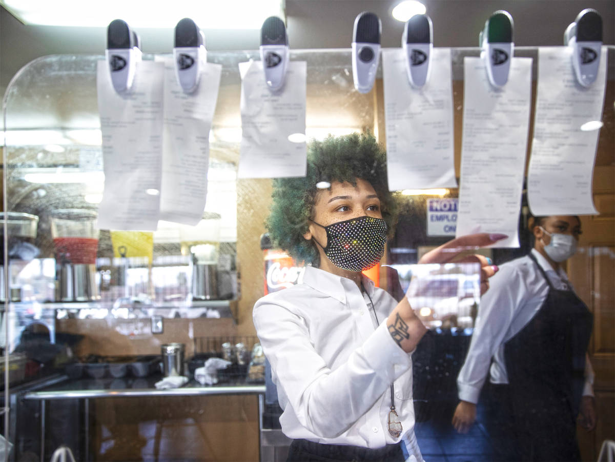 Server Bloo Monroe checks on orders at Chef Carol's Southern Kitchen on Saturday, Feb. 20, 2021 ...