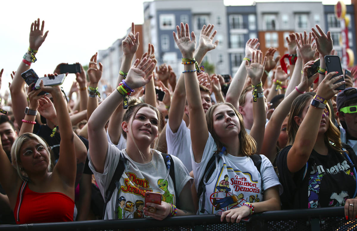 Attendees cheer as Oliver Tree, not pictured, performs at the Bacardi stage during day three of ...