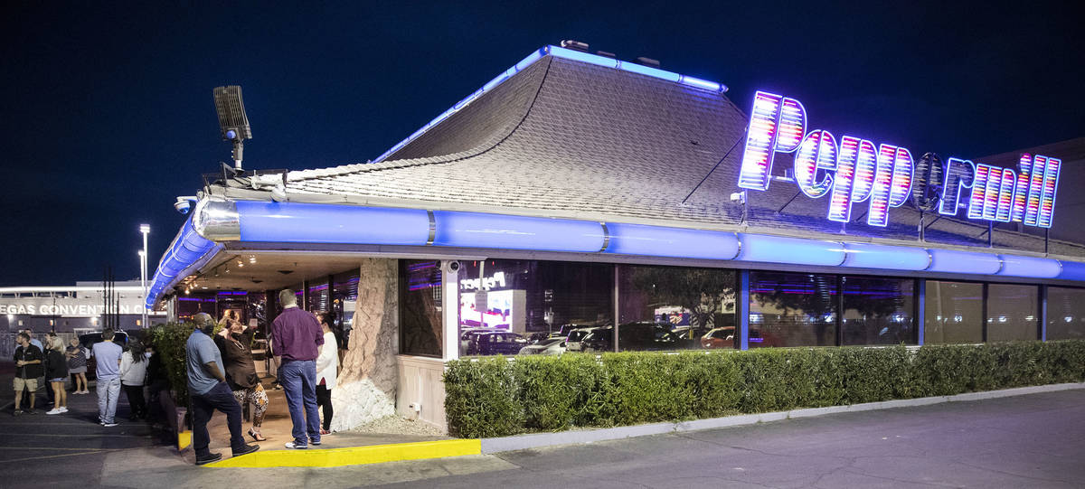 People wait for a table outside of the Peppermill Las Vegas restaurant March 19. (Erik Verduzco ...