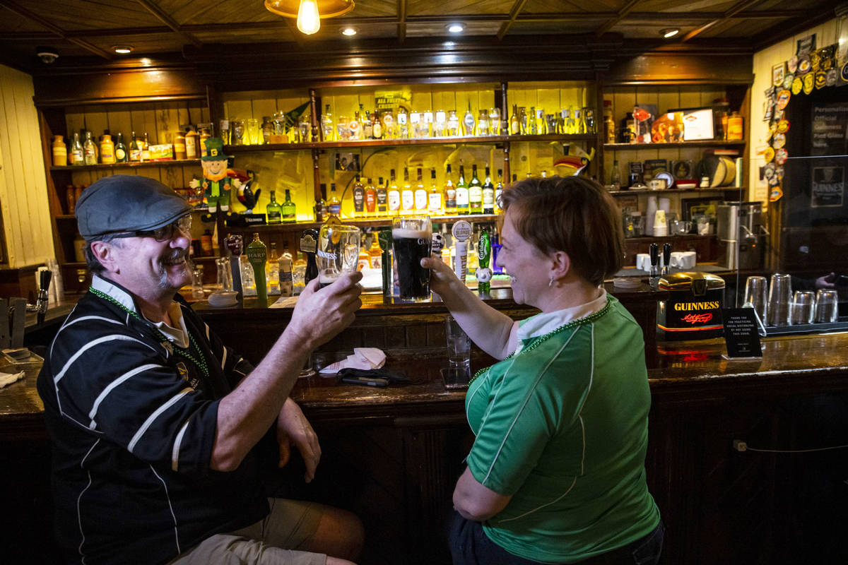 Arthur McFarland, left, and Kim McFarland toast as people gather to celebrate St. Patrick's Day ...