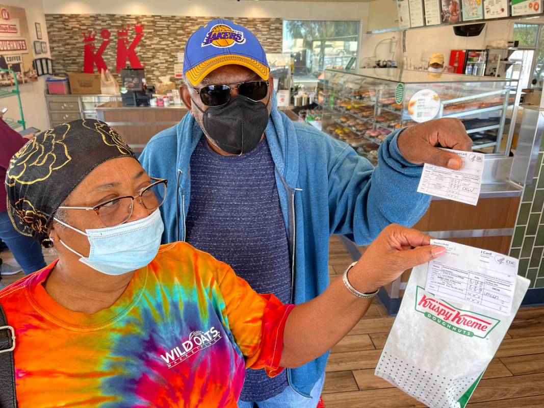 Debi and Willis Powell show their free doughnuts at Kirspy Kreme on Craig Road in North Las Veg ...