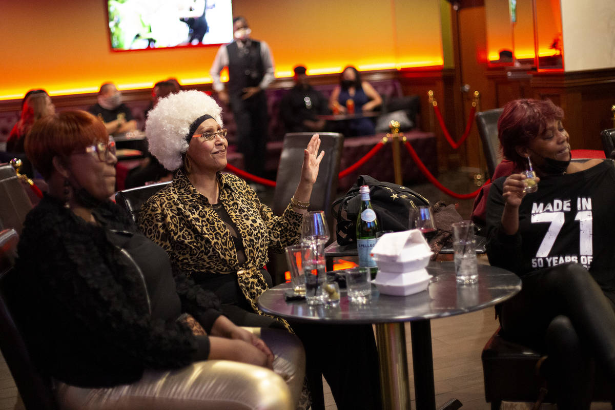 Lynn Clark, left, a person who identified herself as Ms. DVA and Tasha Jones Eaton dance along ...