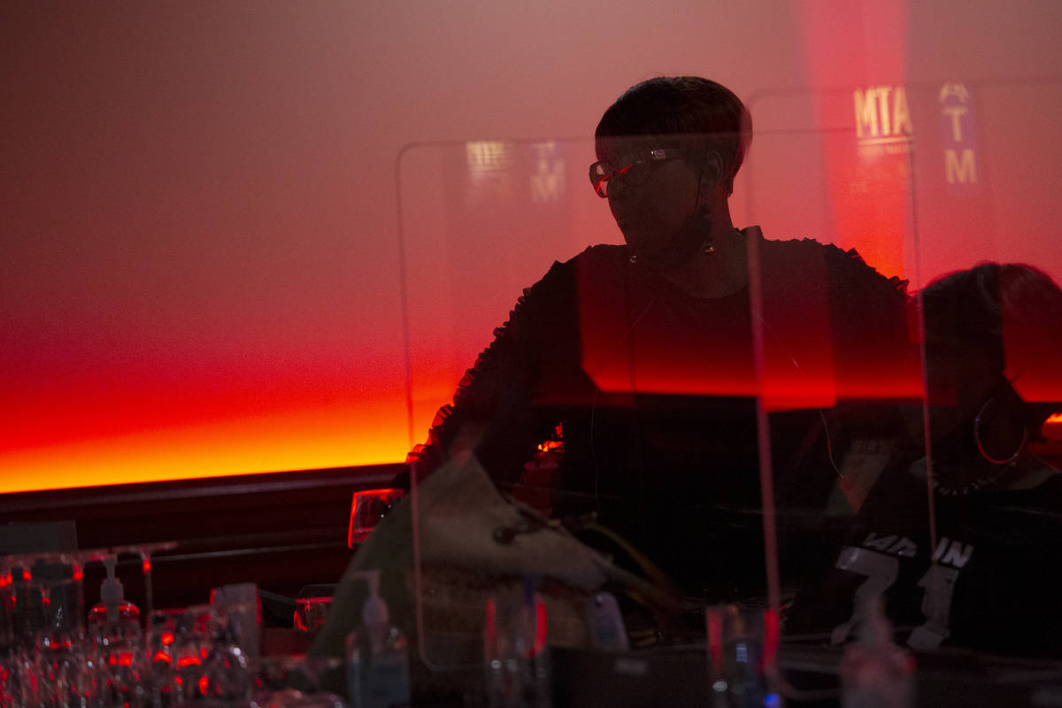 Bar patrons wait for their beverages at West Side Oasis on Friday, March 26, 2021, in Las Vegas ...
