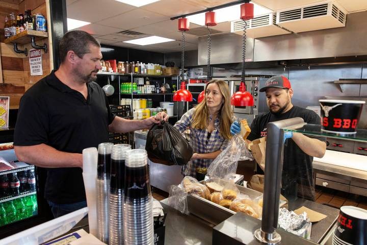 Brian Buechner, left, and wife Natalia Badzjo, owners of Big B's Texas BBQ, prepare an order wi ...