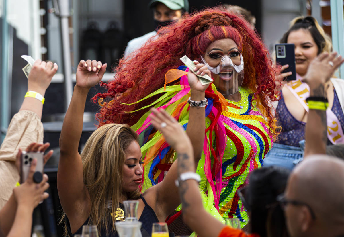 Drag queen Coco Montrese collects tips while performing during the "Bottomless Drag Brunch ...