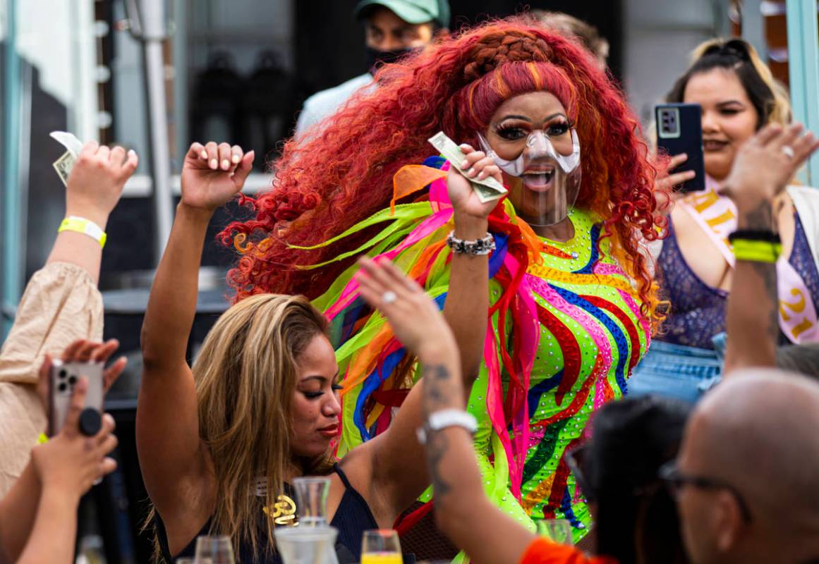 Drag queen Coco Montrese collects tips while performing during the "Bottomless Drag Brunch ...