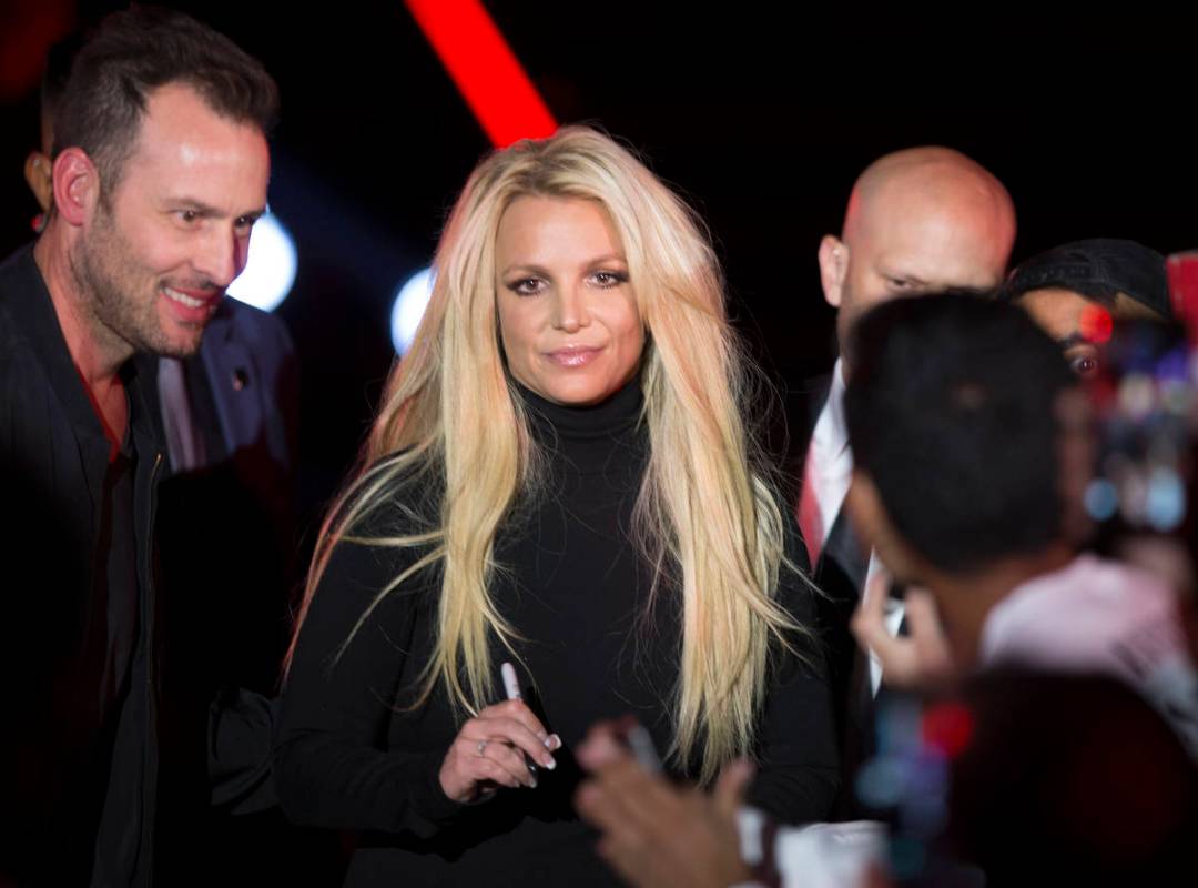 Britney Spears signs an autograph during an event to announce her residency at The Park Theater ...