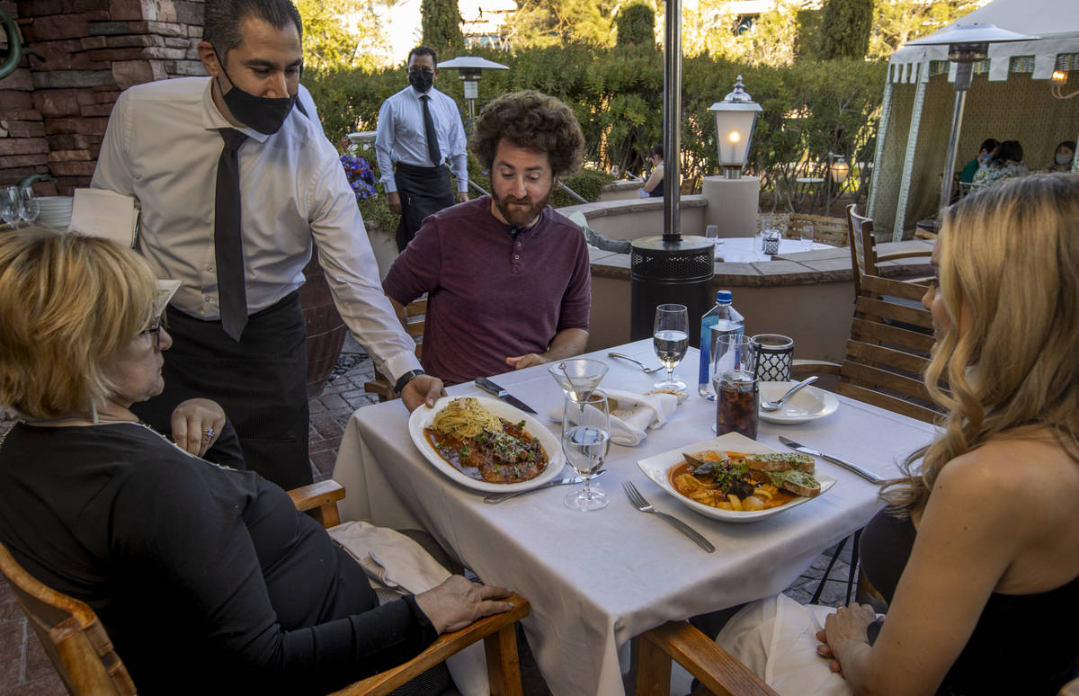 Linda Frederick Colom, from left, is served by Gilbert Salgado while joined by Brian and Tori B ...