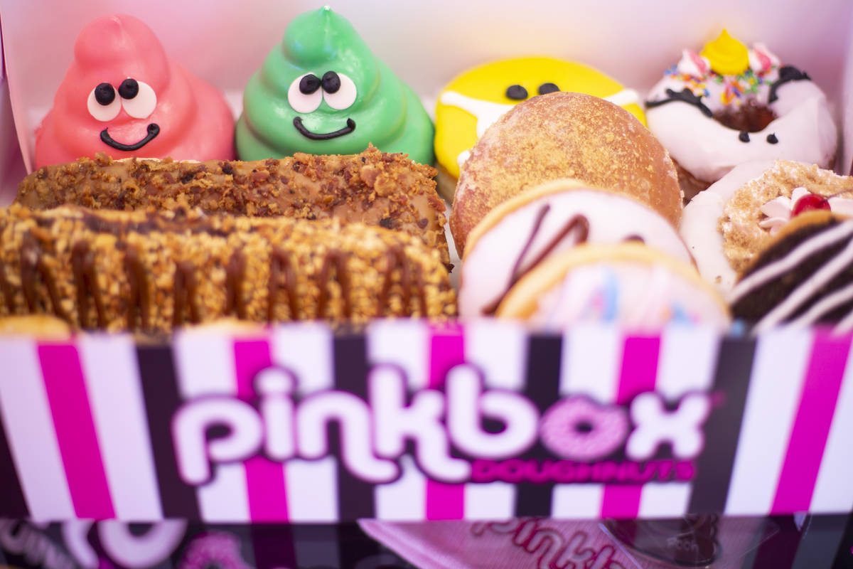 A dozen doughnuts are displayed at the new Pinkbox Doughnuts, opening April 10, on East Sunset ...