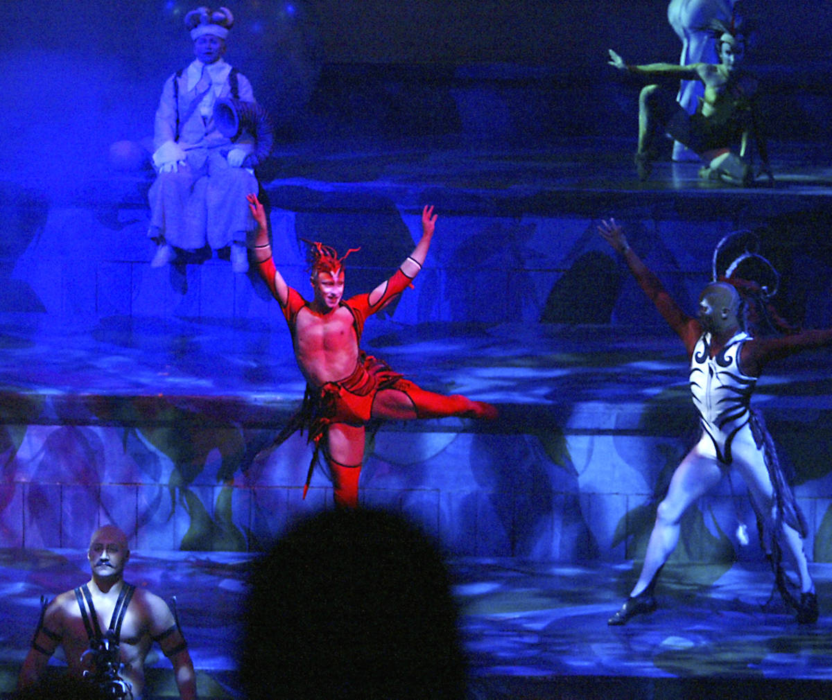 Cast members perform during the Cirque du Soleil "Mystere" show in the Mystere Theater at Treas ...