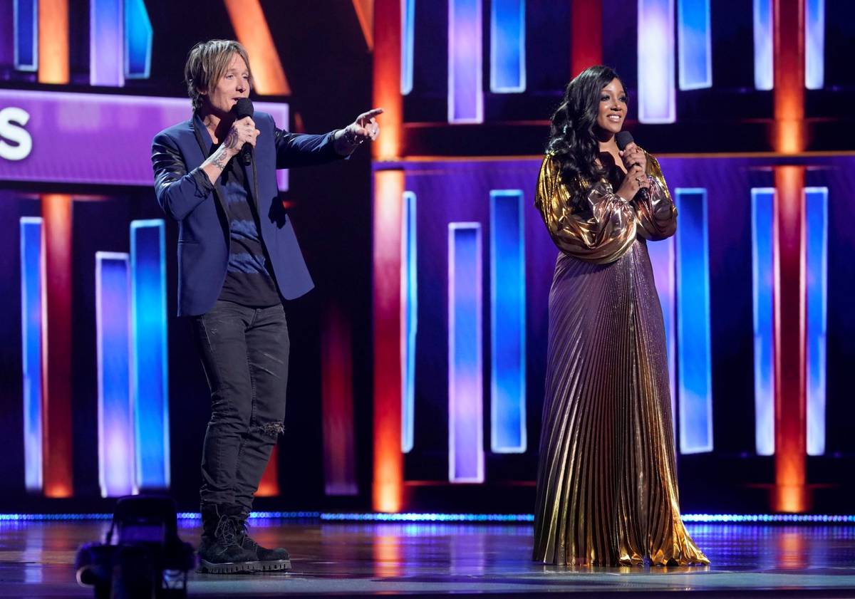 Hosts Keith Urban, left, and Mickey Guyton speak at the 56th annual Academy of Country Music Aw ...