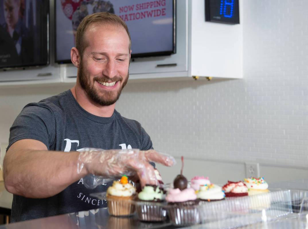 Max Jacobson-Fried, owner of Freed's Bakery, packs up some cupcakes at the Freed's dessert shop ...
