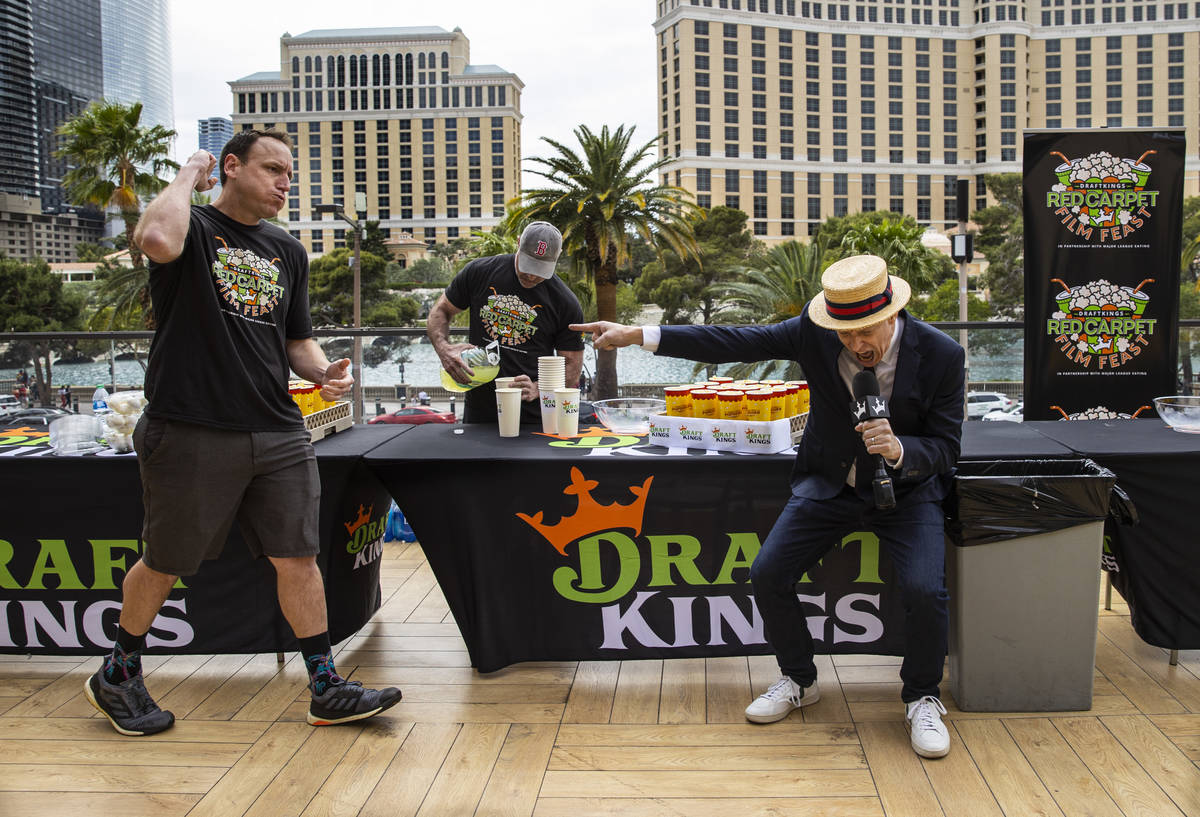 Competitive eating world champion Joey Chestnut, left, is introduced by George Shea, right, as ...