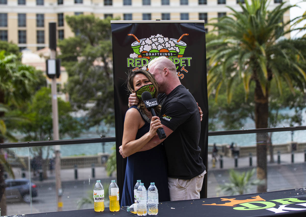Contest winner Nick Wehry, who ate 50 hard boiled eggs, embraces his fiance and fellow world ea ...