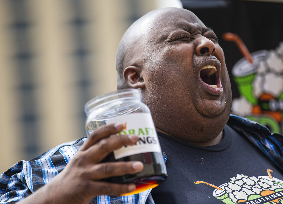Eric Badlands Booker, left, burps while competing against Derek Hendrickson in the soda chuggin ...