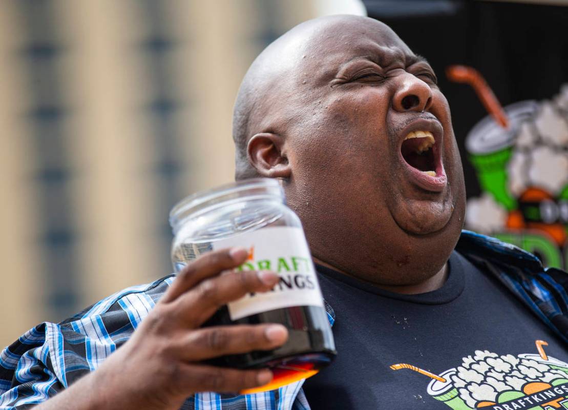 Eric Badlands Booker, left, burps while competing against Derek Hendrickson in the soda chuggin ...