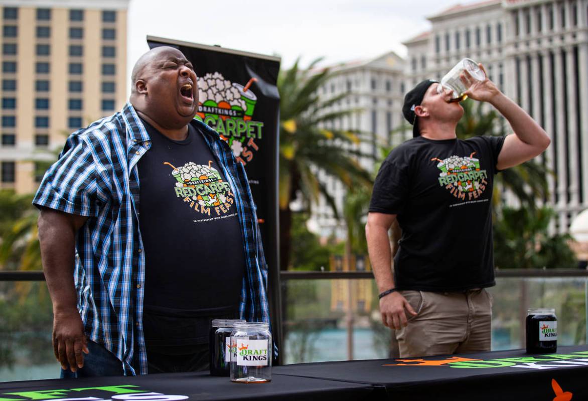 Eric Badlands Booker, left, burps while competing against Derek Hendrickson in the soda chuggin ...