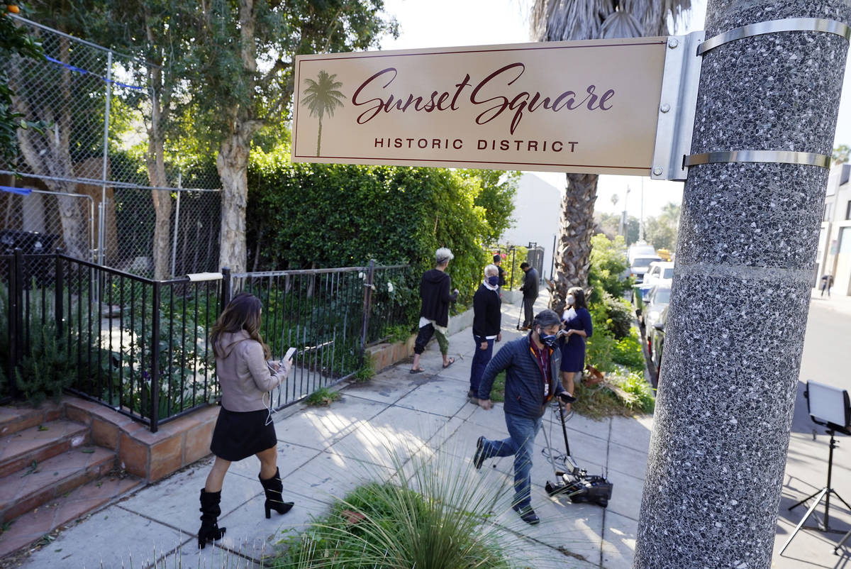 In this Thursday, Feb. 25, 2021, file photo, members of the media and neighbors walk near an ar ...