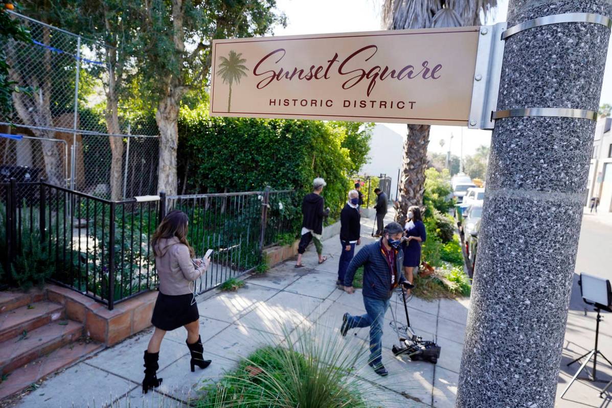 In this Thursday, Feb. 25, 2021, file photo, members of the media and neighbors walk near an ar ...