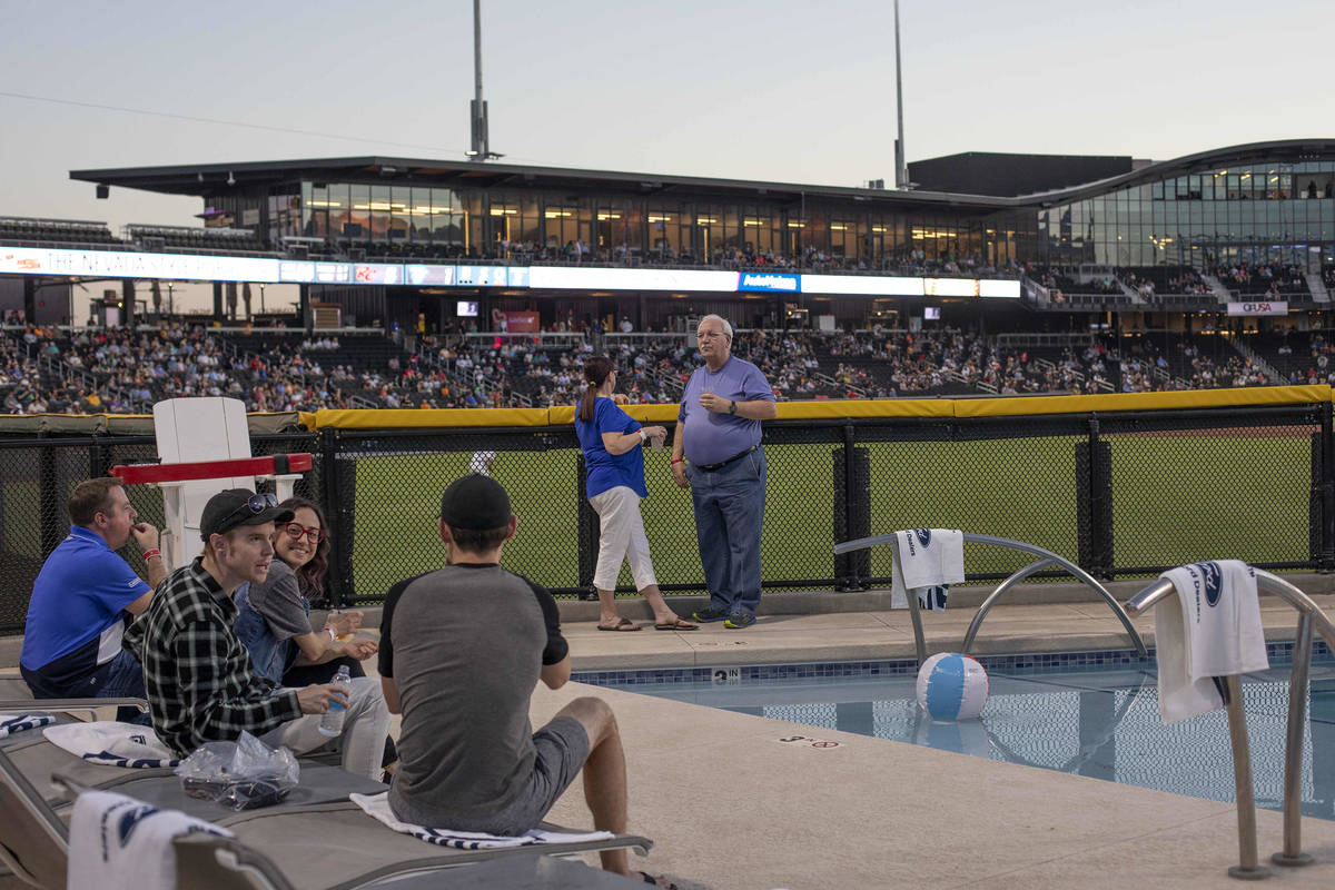 Diana Hildebrand, center left, and Mike Hildebrand enjoy a Las Vegas Aviators game against the ...