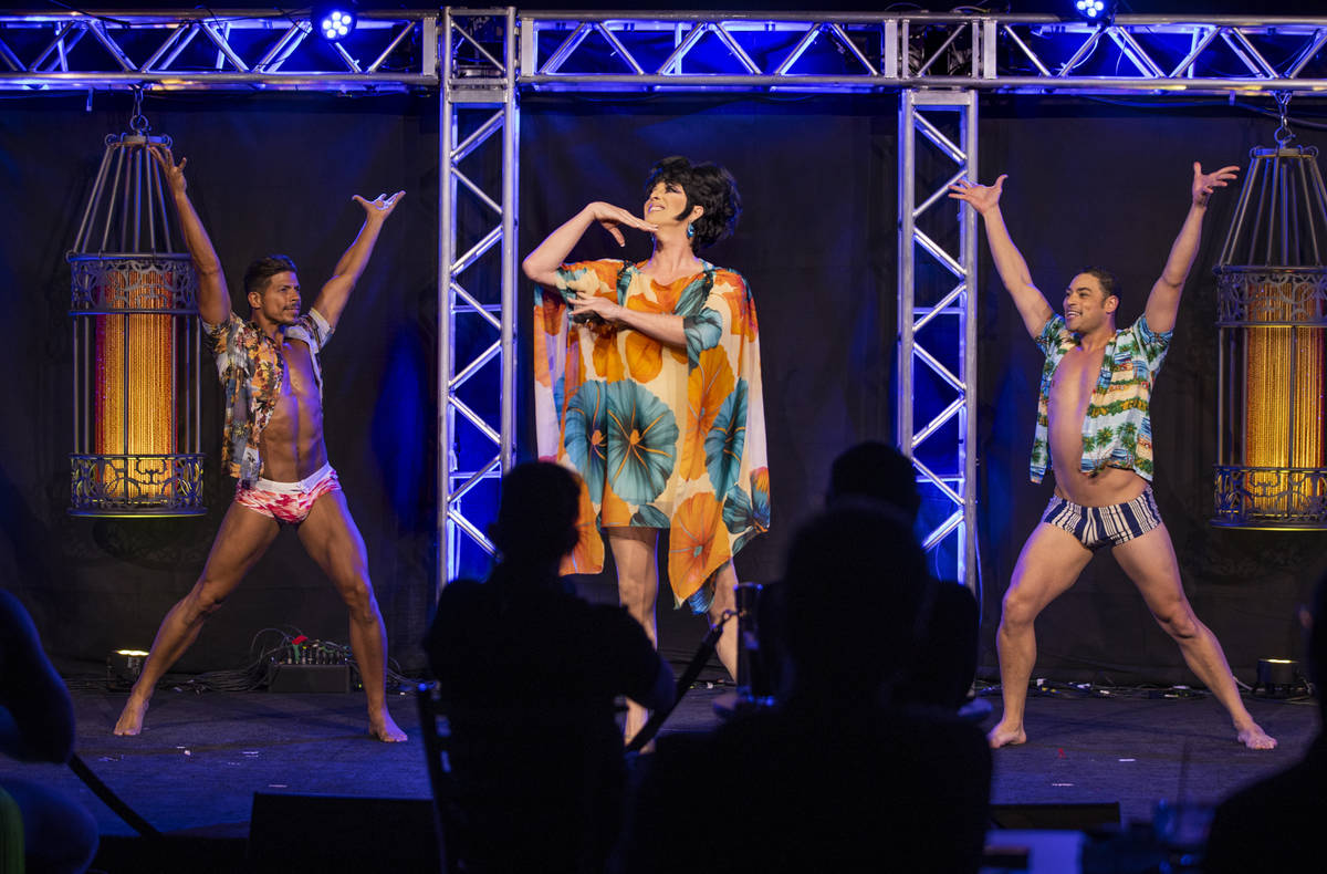 Edie performs "Blue Moon" with dancers Joe Rivera, left, and Curtis Goodman during an ...