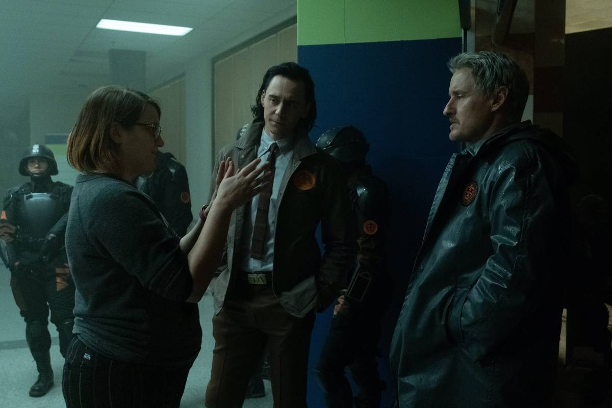 Director Kate Herron talks with Tom Hiddleston, left, and Owen Wilson on the set of the Disney+ ...