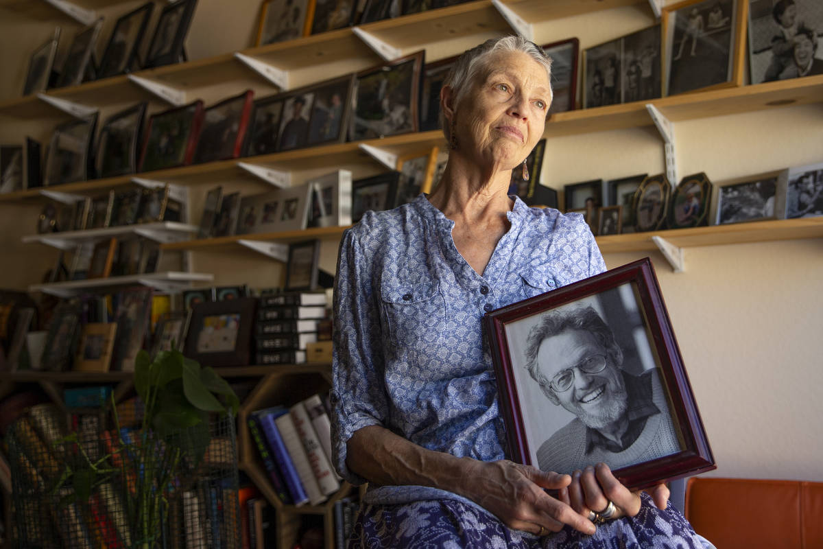 Judy Polumbaum, daughter of news photographer Ted Polumbaum, holds a photo of her father at her ...