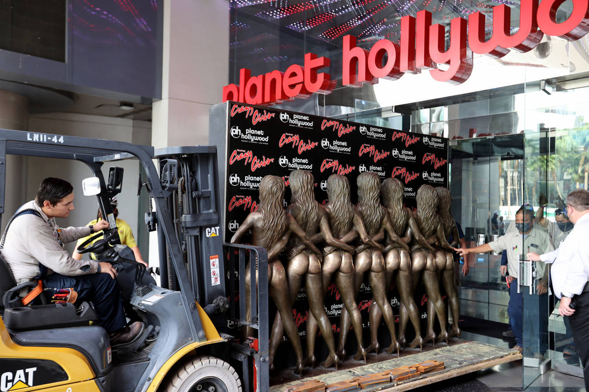 Workers move the "Crazy Girls" bronze statue from Planet Hollywood Resort, Tuesday, June 15, 20 ...
