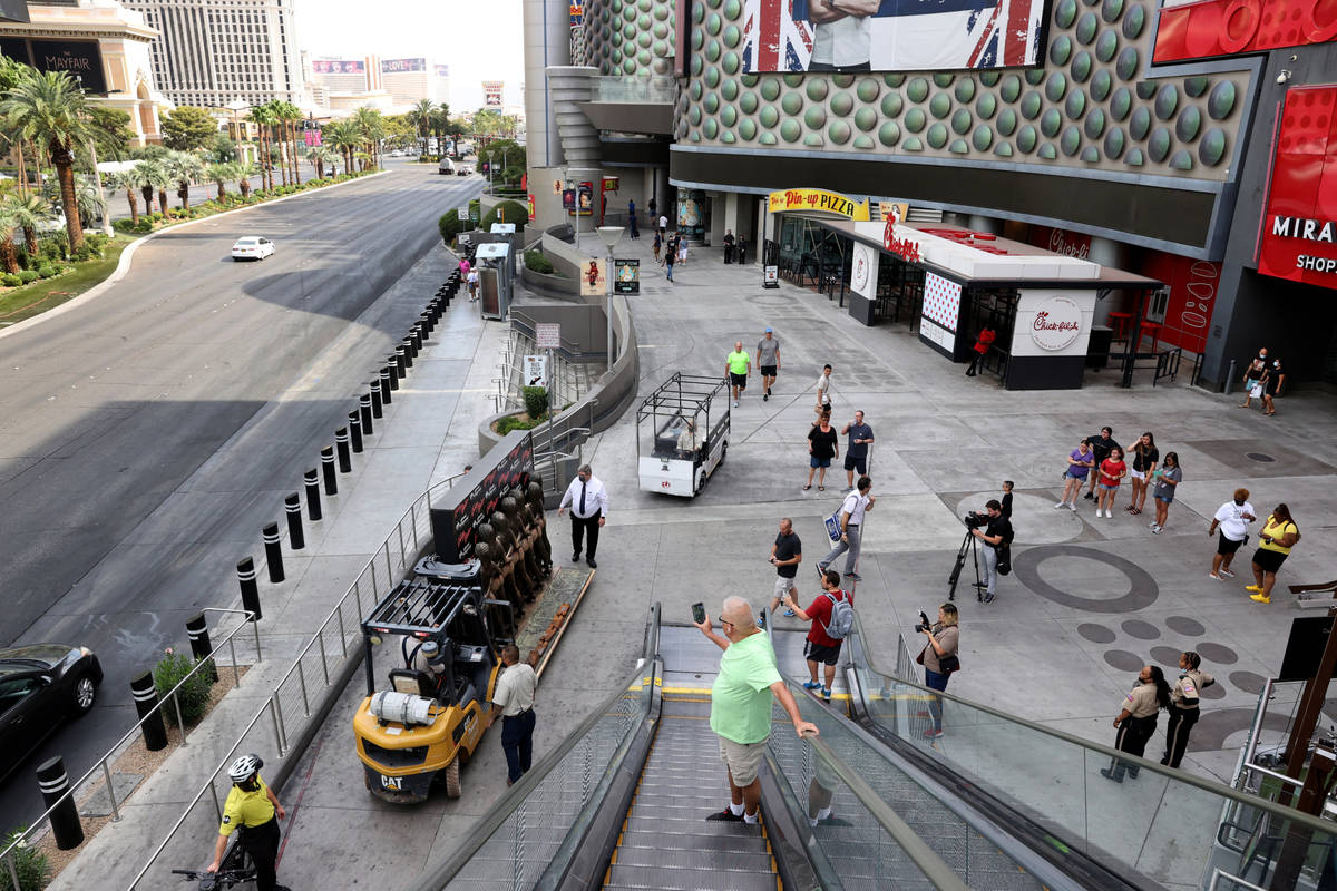 Workers move the "Crazy Girls" bronze statue from Planet Hollywood Resort on the Las Vegas Stri ...