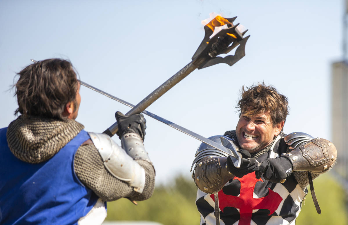 Arms clash as Sir Jeffrey the Blue Knight, left, and Sir Anthony the Black Knight fight to the ...