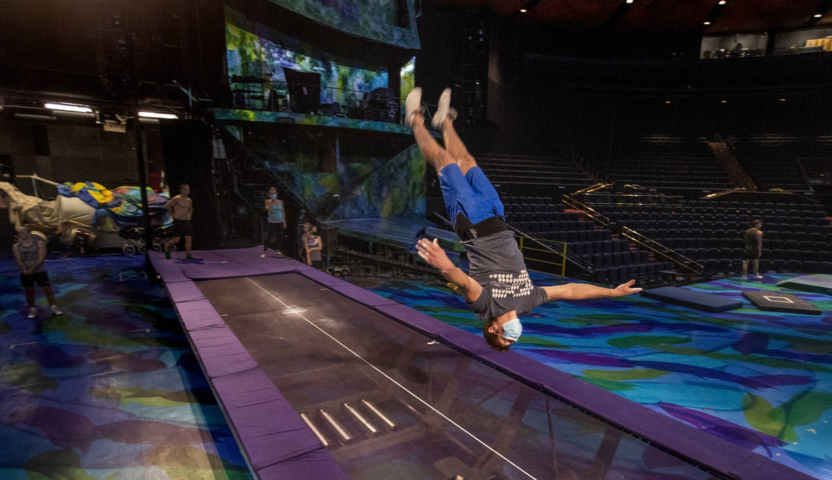 An acrobat practices flips on a power track trampoline during rehearsals for "Mystere,&quo ...