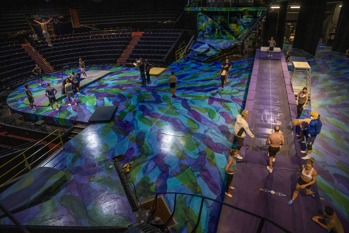 Acrobats practices flips on a power track trampoline, right, as others use a teeter board durin ...
