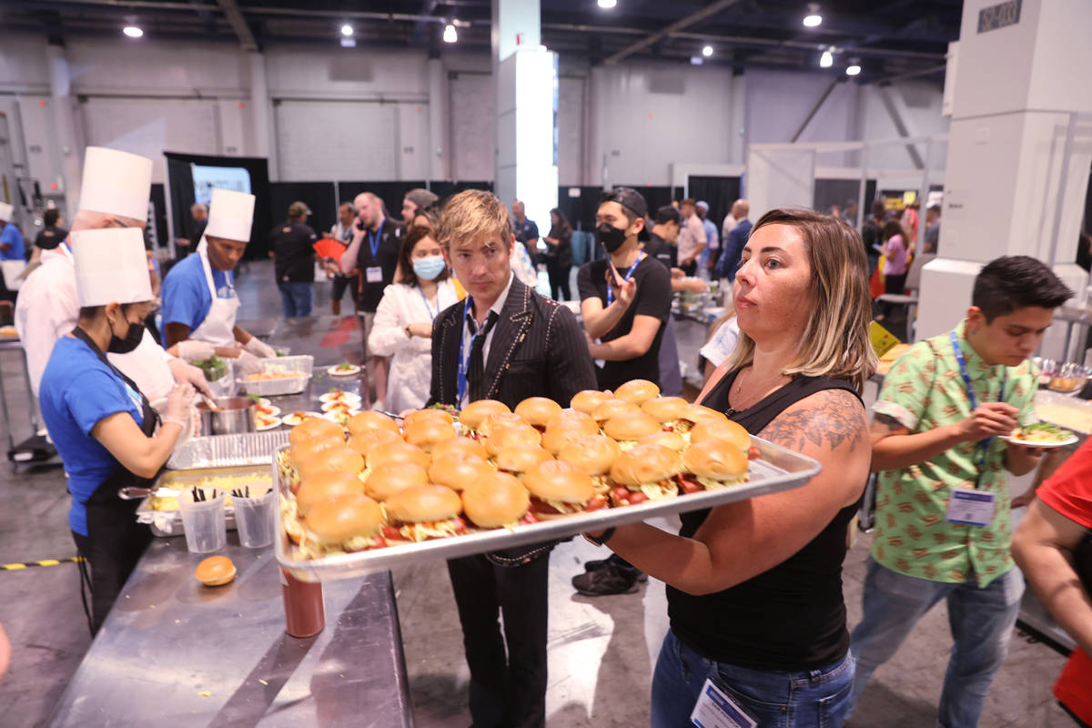Samantha Perdick loads hot dog sliders at the Nightclub & Bar Show at the Las Vegas Convent ...