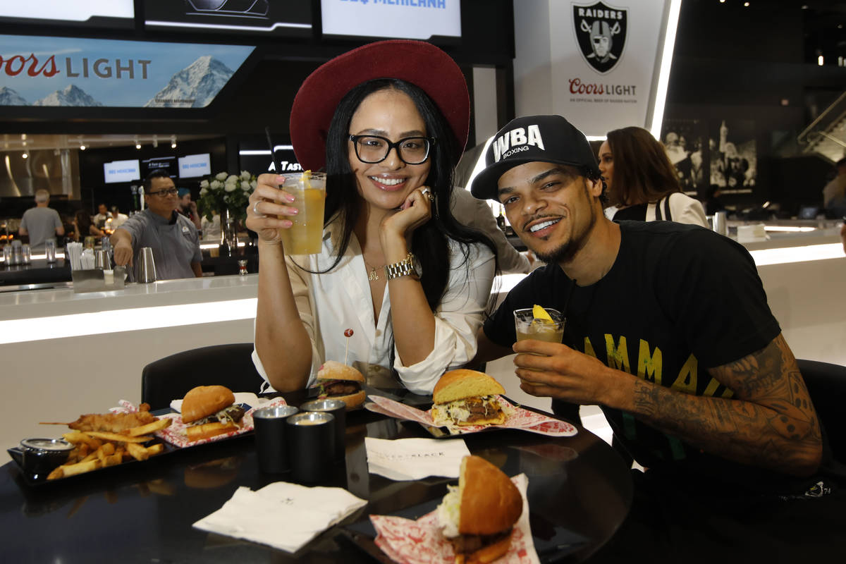 Michelle Belfrey, left, and her fiancé Lahvonne Fields, right, both from Las Vegas, pose for a ...