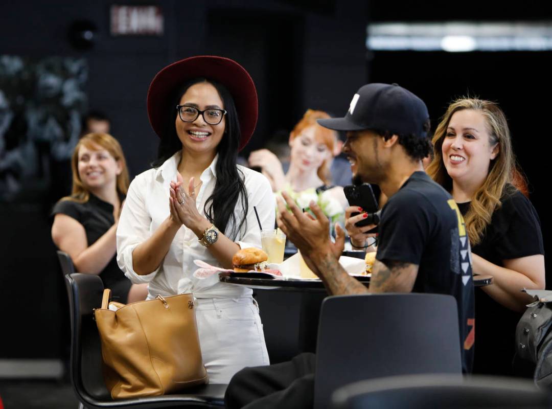 Guests including Michelle Belfrey, left, and her fiancé Lahvonne Fields, right, both from Las ...