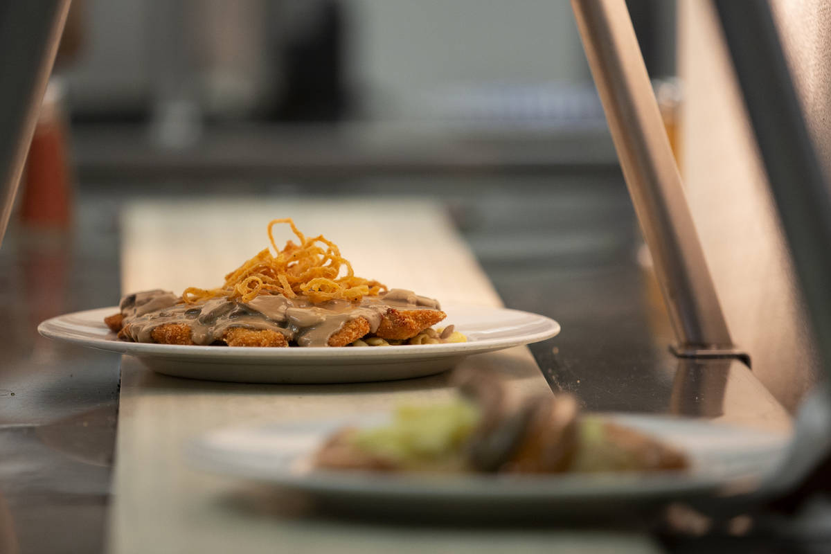 The "Gegrillte Hhnchenbrust," chicken in mushroom sauce, heads down the conveyer belt ...