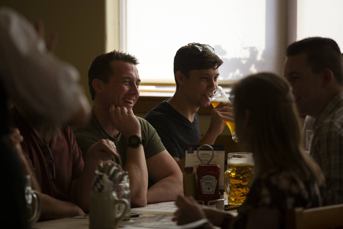 Diners enjoy their beers before ordering traditional German cuisine at Hofbrauhaus on Thursday, ...